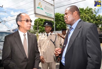 National Security Minister, Hon. Dr. Horace Chang (right),  and other members of the congregation of the Washington Gardens Seventh-day Adventist Church in Kingston, listen as members of the Jamaica Constabulary Force chorale renders a song, during a commemorative service on April 7 to mark the organisation’s 150th anniversary.

