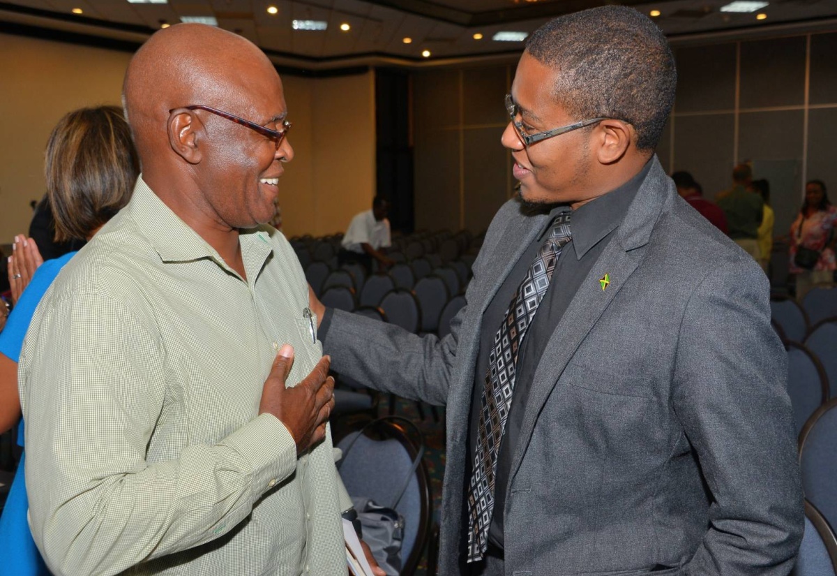 State Minister for Education, Youth and Information, Hon. Floyd Green (right), is in light conversation with economist, Dennis Jones, following the Inter-American Development Bank’s (IDB) Public Lecture on the theme: ‘The 4th Revolution – The Global Race to Reinvent the State,’ held on May 2, at the Jamaica Pegasus Hotel in New Kingston.