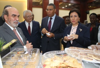 The Most Hon. Andrew Holness (2nd right), Prime Minister of Jamaica, and Dr. Margarita Cedeño, Constitutional Vice-President of the Dominican Republic Special Ambassador of the Food & Agriculture Organization (FAO), sample pastry during a tour of the exhibition at the Opening Ceremony of the 35th Session of the FAO Regional Conference for Latin America and Caribbean held at the Montego Bay Convention Centre in Rose Hall, St. James, on Wednesday, March 7, 2018. Others from left are Dr José Graziano da Silva, Director General, FAO, and Hon Karl Samuda, Minister of Industry, Commerce, Agriculture and Fisheries.