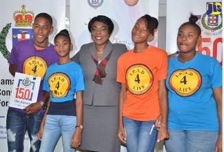 Acting Commissioner of Police, Novelette Grant (centre) with participants of the Jamaica Constabulary Force (JCF) IPAD Youth Empowerment and Mentorship Camp programme, following a corporate breakfast on March 29 at the Terra Nova All-Suite Hotel in Kingston, which was used to seek sponsorship for the expansion of the programme. IPAD, an acronym for Identity, Purpose, Attitude, Destiny, is aimed at social intervention for youth. 