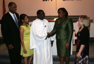 Newly installed pastor of the Faith Moravian Church of the Nation’s Capital in Washington DC, Jamaican-born Rev. Bevon White (centre), receives warm congratulations from Deputy Chief of Missions at the Embassy of Jamaica, Marsh Coore-Lobban (2nd right), at the installation service held at the church on Sunday (Sept. 29). Sharing in the occasion are (l-r) President of the Church Council, Dr. Horace McCormack; Rev. White wife, Mrs. Cecile White; and Executive Board member of the Eastern District of the Moravian church, Peg Grenier.