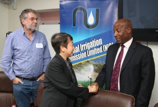 National Irrigation Commission (NIC) Chairman, Senator Aubyn Hill (right), greets Technical Officer from the International Atomic Energy Agency (IAEA)  in Vienna, Austria, Lena Heng (centre), at the opening of  a four-day workshop titled ‘Optimizing Irrigation Water Management to Improve Crop Output and Water Quality Control’, at the Ministry’s offices in St. Andrew on August 22. At left is Manager of Agronomic Research and Development at Sentek Technologies in Adelaide, South Australia, Peter Buss. 