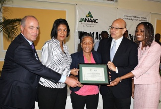 Jamaica National Agency for Accreditation (JANAAC) Chief Executive Officer, Sharonmae Shirley (right), holds accreditation certificate presented to the University of the West Indies (UWI), Mona Campus’ Microbiology Diagnostic Services Laboratory, at a JANAAC forum, held at the Terra Nova All-Suite Hotel in Kingston on June 9.  Also holding the certificate (from left) are Chairman of the Inter-American Accreditation Cooperation, Randy Dougherty; Head of the Microbiology Department at UWI, Dr. Alison Nicholson; Technical Manager for the Microbiology Department, Professor Monica Smikle and JANAAC Chairman, Simon Roberts. 