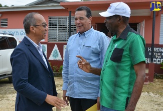 Minister without Portfolio in the Ministry of Industry, Commerce, Agriculture and Fisheries, Hon. J.C. Hutchinson  (right),  speaks with Minister without Portfolio in the Ministry of Economic Growth and Job Creation, Hon. Dr. Horace Chang (left); and Chairman of the Rural Water Supply Company, Homer Davis. Occasion was the commissioning of a water, energy and sanitation project at the Beersheba Primary School in St. Elizabeth on Friday (October 14).