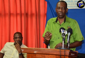 Minister without Portfolio in the Ministry of Industry, Commerce, Agriculture and Fisheries, Hon. J.C. Hutchinson (right) addresses a meeting held at the Rural Agricultural Development Authority (RADA) offices in Catherine Hall, St. James on Thursday, August 11. Looking on is Acting Chief Executive Officer of RADA, Peter Thompson.