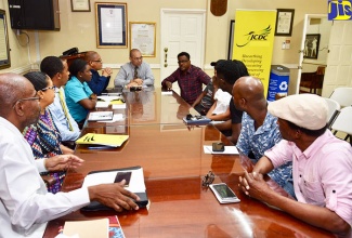 Interim Executive Director of the Jamaica Cultural Development Commission (JCDC), Orville Hill (head of table), leads a meeting involving board commissioners, songwriters and producers at the JCDC’s head office in Kingston on Thursday (November 17). The meeting was held ahead of the launch of the Festival Song Competition 2018 on November 30.