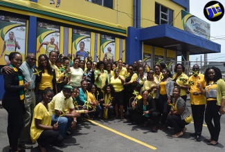 Minister of Culture, Gender, Entertainment and Sport, Hon. Olivia Grange (4th right, second row), shares a moment with the Jamaica Information Service’s (JIS) Chief Executive Officer,  Donna Marie Rowe (5th right), and staff outside the agency’s head office in Kingston recently. Ms. Grange visited the JIS to view displays mounted as a part of the ‘Spirit of Independence’ competition organized by the Jamaica Cultural Development Commission (JCDC). 