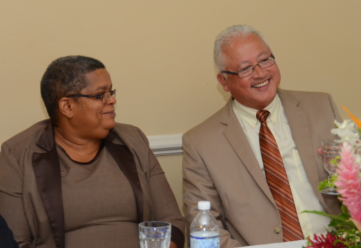 Justice Minister, Hon. Delroy Chuck (right), shares pleasantries with Permanent Secretary in the Ministry, Carol Palmer, during Thursday’s (May 26) installation ceremony for 14 newly appointed Justices of the Peace for St. Thomas, at the Whispering Bamboo Cove Resort at Retreat in the parish. Mr. Chuck was the keynote speaker.