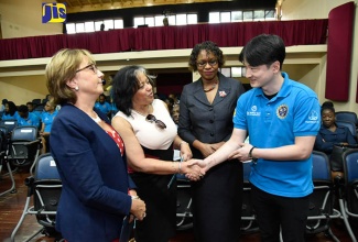 Permanent Secretary in the Ministry of Science, Energy and Technology, Hillary Alexander (second left), greets animation instructor, Creative Industries Education and Employment Programme (CIEEP), Jae Pil Jeong (right), during the closing ceremony for phase one of CIEEP at the Edna Manley College of the Visual and Performing Arts in Kingston, recently. Others (from left) are: World Bank Country Manager for Jamaica, Galina Sotirova; and Principal, Edna Manley College of the Visual and Performing Arts, Nicholeen Degrasse Johnson. During the ceremony, 150 animators were presented with certificates, having acquired competencies in five highly specialized areas of 3D animation.