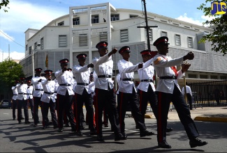 Members of the Jamaica Constabulary Force (JCF) march past the Supreme Court in downtown Kingston.     