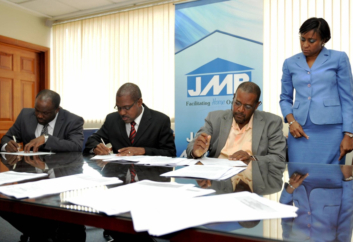 Company Secretary and Legal Counsel for Jamaica Mortgage Bank (JMB),  Donna Samuels-Stone, oversees the signing of  a syndicated loan agreement  between financiers Jamaica Mortgage Bank (JMB) and National Commercial Bank (NCB); and 138 Student Living Jamaica Ltd. Under the agreement, the two financial entities will provide $1.35 billion for the construction of phase one of a student housing project at the University of the West Indies (UWI). The signatories  (from left)  are: Assistant General  Manager Corporate Banking at NCB, Raymond Donaldson; General Manager, Corporate Banking NCB, Brian Boothe and JMB Board Chairman, Howard Mollison.  