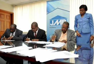 Company Secretary and Legal Counsel for Jamaica Mortgage Bank (JMB),  Donna Samuels-Stone, oversees the signing of  a syndicated loan agreement  between financiers Jamaica Mortgage Bank (JMB) and National Commercial Bank (NCB); and 138 Student Living Jamaica Ltd. Under the agreement, the two financial entities will provide $1.35 billion for the construction of phase one of a student housing project at the University of the West Indies (UWI). The signatories  (from left)  are: Assistant General  Manager Corporate Banking at NCB, Raymond Donaldson; General Manager, Corporate Banking NCB, Brian Boothe and JMB Board Chairman, Howard Mollison.  