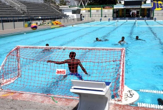 Members of the Jamaican water polo team take part in a practice session at the recently upgraded National Aquatic Centre at the National Stadium in Kingston, on March 14, when the upgraded facility was handed over by Minister of Culture, Gender, Entertainment and Sport, Hon. Olivia Grange. 