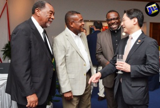 Tourism Director, Paul Pennicook (2nd left), has a light moment with the Governor of Tottori Prefecture, Japan, Shinji Hirai (right), at a welcome reception for the Governor and his delegation, held on July 17 at the Couples Swept Away Resort in Negril, Westmoreland. Mayor of Savanna-la-Mar, Councillor Bertel Moore (left) and Custos of Westmoreland, The Very Reverend Canon, Hon. Hartley Perrin, also share the moment.