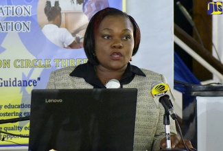 Regional Director, Region One, Ministry of Education, Youth and Information, Dr. Kasan Troupe, converses with Member of Parliament for East Central St. Andrew, Dr. Peter Phillips, at the official launch of Quality Education Circle (QEC) 3 , during a ceremony held at the Merl Grove High School Auditorium in St. Andrew on February 8.