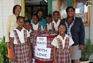 Principal of the John Rollins Success Primary School in Rose Hall, St. James,  Yvonne Miller Wisdom (right); Administrative Assistant, Hervilyn Forbes (centre); Teacher, Margaret Harwood; and students, stand beside the attractively decorated drum in which the school is accepting relief supplies for Haitian students. The school is collecting canned foods, items of clothing, water and toiletries, which will be sent to Haiti through Food For The Poor to assist young victims of Hurricane Matthew.