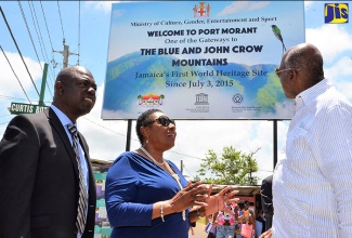 Minister of Culture, Gender, Entertainment and Sport, Hon. Olivia Grange (centre), emphasises a point to Member of Parliament for St. Thomas Eastern, Dr. Fenton Ferguson (right), following the unveiling of the gateway sign to the  Blue and John Crow Mountains World Heritage Site in Port Morant, St. Thomas on June 8. At left is Chairman of the St. Thomas Municipal Corporation, Mayor Lenworth Rawle.