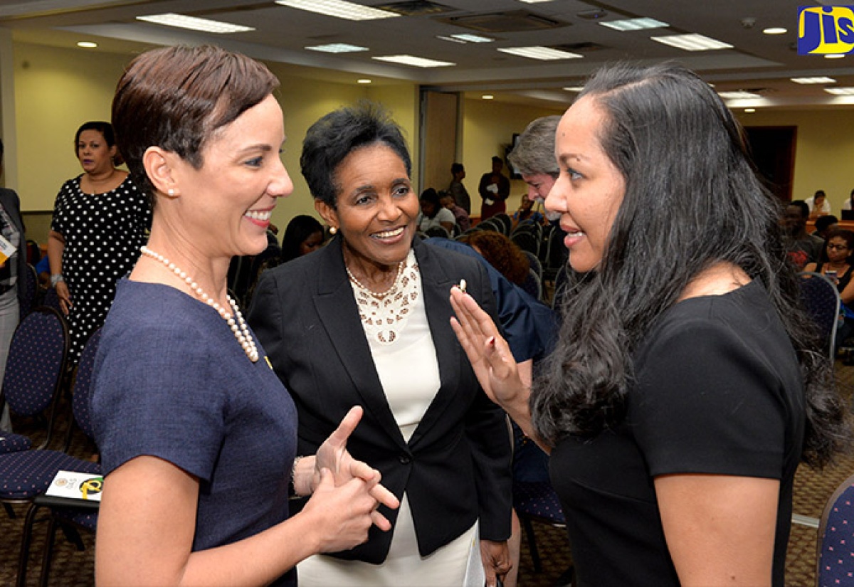 Foreign Affairs and Foreign Trade Minister, Senator the Hon. Kamina Johnson Smith (left), listens to a point being made by the Organization of American States (OAS) Representative in Jamaica, Jeanelle van Glaanen Weygel (right), at the opening ceremony of the organisation’s 70th anniversary celebrations, at the Regional Headquarters of the Mona Campus of the University of the West Indies, on March 5. At centre is Permanent Secretary in the Foreign Affairs and Foreign Trade Ministry, Ambassador Marcia Gilbert Roberts. 