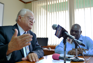 Minister of Industry, Commerce, Agriculture and Fisheries, Hon. Karl Samuda (left), addresses a press conference at the Ministry’s offices in New Kingston earlier this week. Listening is Permanent Secretary, Donovan Stanberry.