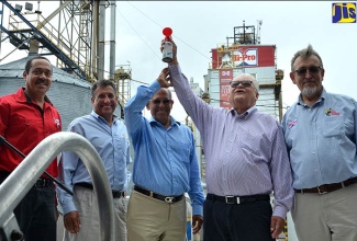 Minister of Industry, Commerce, Agriculture and Fisheries, Hon. Karl Samuda (2nd right), symbolically commissions into service the new US$2 million pellet mill at the Jamaica Broilers Group’s Best Dressed Plant in Freetown, St. Catherine on December 14. Others (from left) are: General Operations Manager at the facility, John Carberry;  President and Chief Executive Officer of the Group, Christopher Levy; Group Chairman, Robert Levy; and President, Jamaica Operations, Jamaica Broilers Group, Conley Salmon.