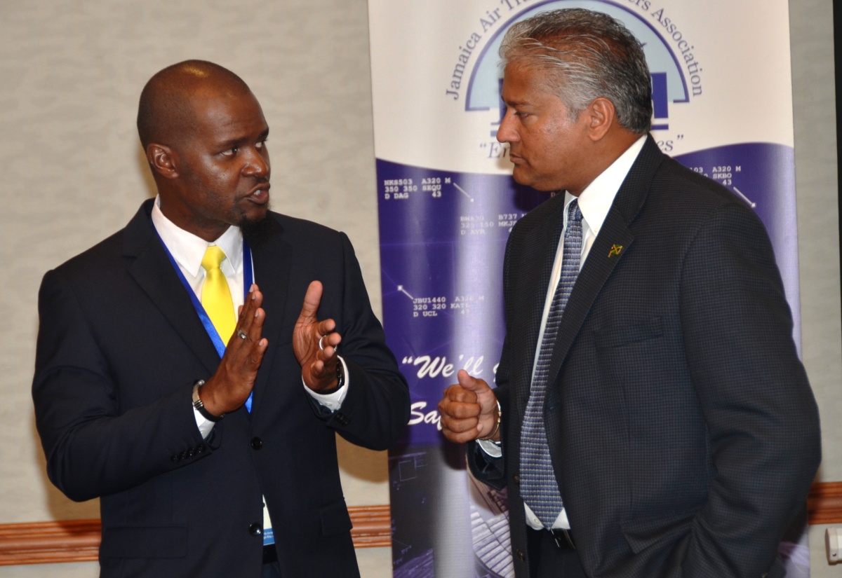 Director General of the Jamaica Civil Aviation Authority (JCAA), Nari Williams-Singh (right), listens keenly to President of the Jamaica Air Traffic Controllers Association (JATCA), Kurt Solomon. Occasion was the opening of the 26th regional meeting of the International Federation of Air Traffic Controllers Association (IFATCA), at the Holiday Inn Resort in Montego Bay on Thursday (October 15). 