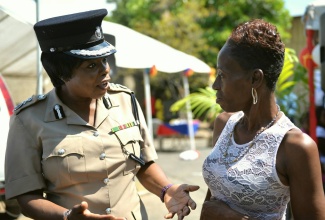 In this file photo, Acting Commissioner of Police, Novelette Grant (left), converses with President of the Denham Town Community Development Centre (CDC), Pauline Perez, prior to the start of an empowerment session held at the Women Resource Outreach Centre’s (WROC) Beechwood Avenue location in Kingston on February 14. 
 
