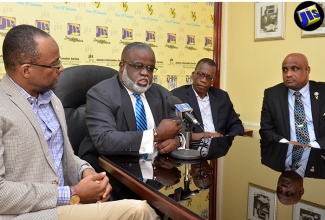 Chairman of the Logistics Hub Initiative, Dr. Eric Deans, shares details about the logistics symposium slated for Saturday, July 23 at the University of the West Indies (UWI) Regional Headquarters, Mona, during a JIS Think Tank on July 20. Looking on are key partners in the staging of the event (from left) Vice-President of Government and Business, Cable and Wireless Business (FLOW), Donovan White (left); Deputy Executive Director and Lecturer, Operations Management at Mona School of Business and Management (MSBM), Dr. Lawrence Nicholson (2nd right); and Executive Director, Caribbean Maritime Institute, Dr. Fritz Pinnock (right).