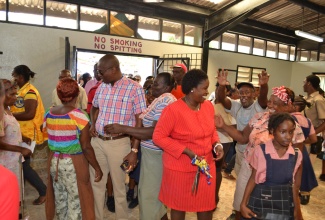 Her Worship the Mayor of Lucea, Councillor Shernet Haughton (Centre), and Minister of State in the Ministry of Water, Land, Environment and Climate Change, Hon. Ian Hayles (third left),walk through the newly opened Fish Market amidst some enthusiastic vendors on June 14. The facility was refurbished by the Hanover Parish Council at a cost of $1 million.
