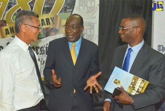 Education, Youth and Information Minister, Senator the Hon. Ruel Reid (centre), is in discussion with Board Director of Alliance Payment Services Limited, Peter Chin (left); and President of The Mico University College, Dr. Asburn Pinnock, at the launch of the ePay Cashless School Programme at the university in Kingston on October 5. 