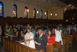 Photo Caption: Charge D’Affaires of the Embassy of Jamaica, Mrs. Marsha Coore-Lobban (front left), joins the large congregation in singing a hymn of praise at the annual church service of thanksgiving commemorating Jamaica’s 53rd year of independence at the Dunbarton Chapel, Howard University School of Law on Sunday, August 2, 2015.  