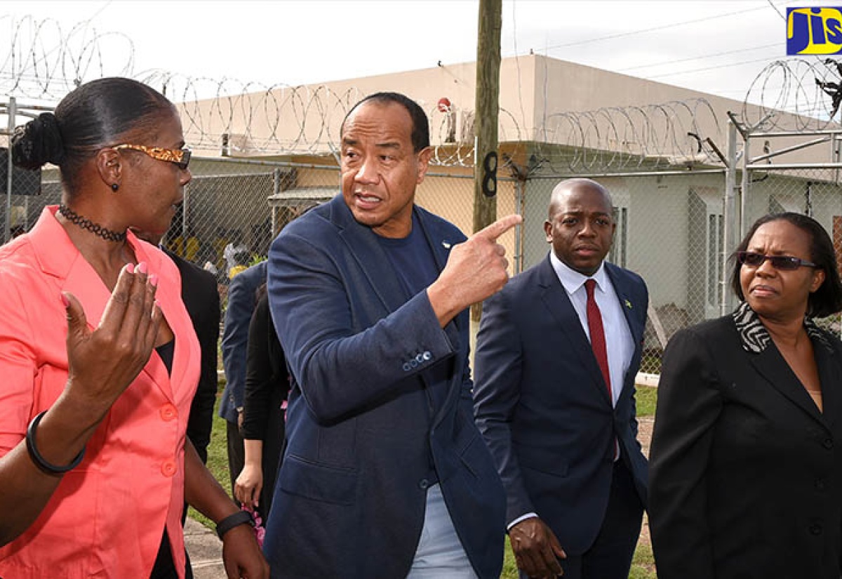 Chairman of the non-profit organization, Trust for the Americas, Michael Lee-Chin (second left), is led on a tour of the South Camp Road Juvenile Remand and Correctional Centre in Kingston on Wednesday (December 13) by Director of the ‘A New Path’ initiative, Susan Ewerse (left).  Others (from third left) are State Minister in the Ministry of National Security, Senator the Hon. Pearnel Charles Jr., and Commissioner of Corrections, Ina Hunter.

