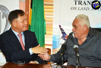 Minister of Transport and Mining, Hon. Mike Henry (right), shakes hands with Ambassador of the Republic of Korea to Jamaica, Lim Jong Seonto, after a press briefing at the Ministry’s Maxfield Avenue offices in Kingston on August 4, to announce a partnership between the Caribbean Maritime Institute (CMI) and the Mokpo National Maritime University in Korea to strengthen the CMI’s training programmes. 