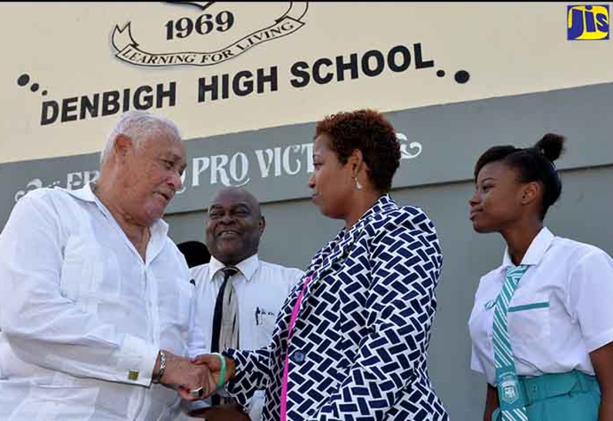 Member of Parliament for Central Clarendon, Hon. Mike Henry (left), is greeted by Principal of Denbigh High School, Janice Julal, when he visited the school recently. Others (from left) are Chairman of the school, Cecil Morgan, and grade-nine student, Janelle Henry. 