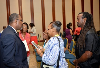 State Minister for Agriculture and Fisheries, Hon. Luther Buchanan (left), converses with delegates attending the 6th Biennial Jamaica Diaspora Conference at the Montego Bay Convention Centre, in St. James, following his presentation at Monday’s (June 15) Agro-parks and Agri-business plenary session, under the theme: ‘Sow, Reap, Profit’. The conference is being held from June 15 to 18, under the theme: ‘Jamaica and the Diaspora: Linking for Growth and Prosperity’. 