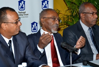 National Housing Trust (NHT)  Chairman, Easton Douglas (centre), addressing journalists on the entity’s acquisition of the Orange Grove property in Trelawny, during a media briefing at the entity’s New Kingston corporate offices,  on Monday (November 24). Flanking him are Board members, Norman Horne (left), and Percival LaTouche.