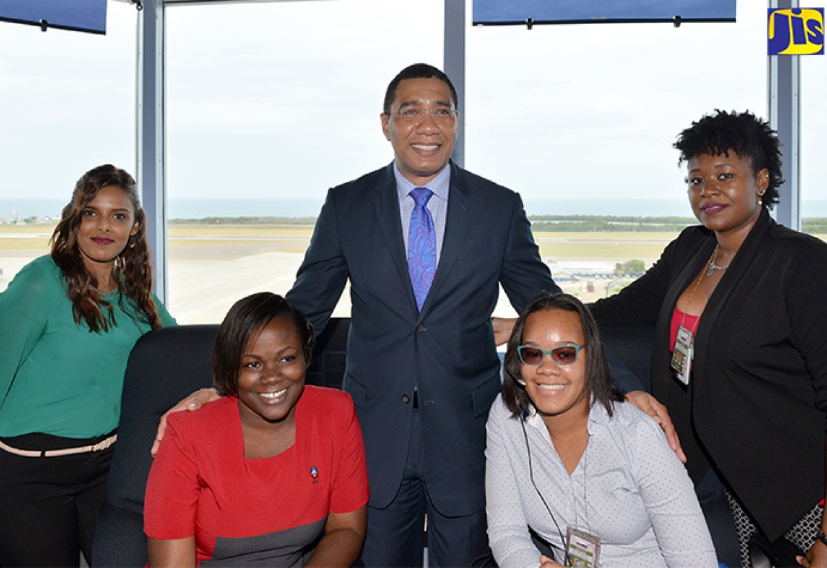 Prime Minister, the Most Hon. Andrew Holness (centre), with air traffic controllers operating out of the recently commissioned state-of-the-art air traffic control tower at the Norman Manley International Airport (NMIA) in Kingston. They are (from left): Sherizah Gallow; Natrecia Goldbourne; Anna-Kay Belcher; and Vanessa Jackson. The Prime Minister was on an official tour of the facility on April 19. The tower and another at Sangster International Airport were constructed at a total cost of $2.57 billion