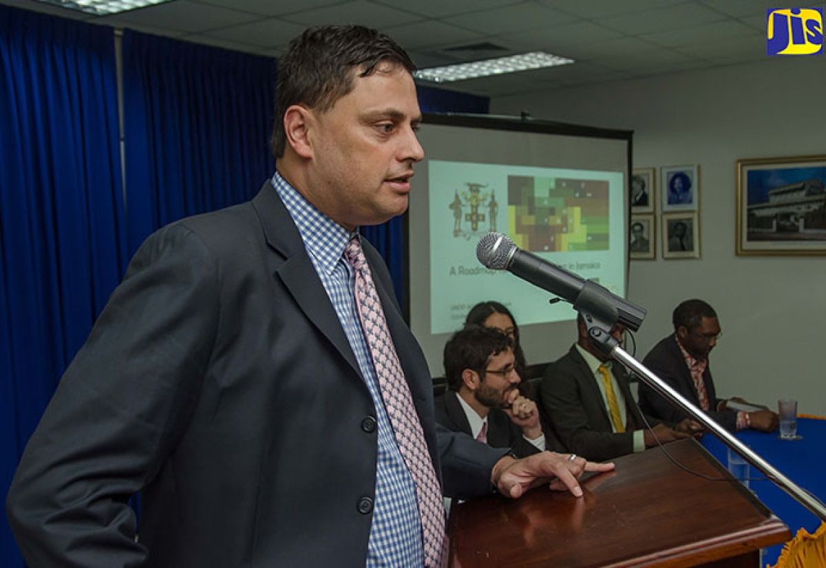 Head of the United Nations Development Programme (UNDP) Mainstreaming Acceleration Policy Support (MAPS) Mission Team, Nik Sekhran, addresses debriefing for the implementation of the UNDP’s Sustainable Development Goals (SDGs) in Jamaica, at the Planning Institute of Jamaica (PIOJ), in New Kingston, on October 28.