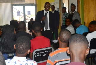 Minister of State in the Ministry of National Security, Senator the Hon. Pearnel Charles Jr. addresses youngsters at the Challengers’ Day Camp at the Portmore Probation Office, recently. 