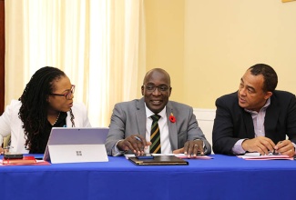 Minister of Health, Dr. the Hon. Christopher Tufton (right), is in discussion with Minister of Education, Youth and Information, Senator the Hon. Ruel Reid (centre) and Press Secretary in the Office of the Prime Minister, Noami Francis prior to the start of Wednesday's (October 4) post-Cabinet press briefing at Jamaica House in Kingston.