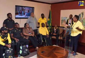 Minister of Culture, Gender, Entertainment and Sport, Hon. Olivia Grange (at podium), addresses a reception at the Norman Manley International Airport in Kingston on April 17 for members of the Jamaica delegation to the 2018 Commonwealth Games held recently in Australia.