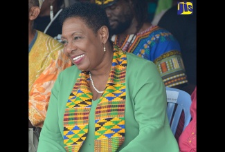 Minister of Culture, Gender, Entertainment and Sport, Hon. Olivia Grange, enjoys a performance at the official ceremony to mark the 280th anniversary of the signing of the Peace Treaty between the Accompong Town Maroons and the British, in Accompong Town,  St. Elizabeth, on January 6.

