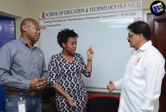 Founder of the Rakul Enterprises School of Education and Technology (RESET), Dr. Raghavan Ramamoorthy, speaks with Business Development Officer at the National Commercial Bank (NCB), Damion Sibbles (left), and Social Officer, Integrated Community Development Project, Jamaica Social Investment Fund (JSIF), Shunelle Nevers. Occasion was the staging of an ornamental fish farming workshop on Friday (September 2), at RESET’s offices, 13 Lower Sandringham Avenue, Kingston 10.