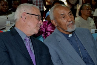 Education Minister, Hon. Rev. Ronald Thwaites (left), has a quick word with Archbishop Emeritus, Rev. Donald James Reece, at the opening session of the St. Joseph’s Teachers’ College’s inaugural Research Day on October 3.