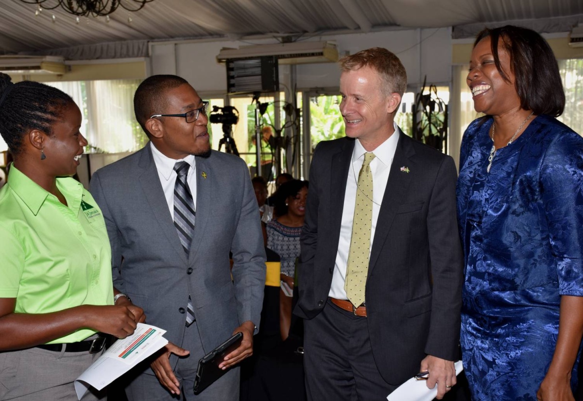 Minister of State in the Ministry of Education, Youth and Information, Hon. Floyd Green (2nd left), enjoys a light moment with (from left): Project Leader, Junior Achievement Company of Entrepreneurs (JACE) Secondary Early Entrepreneurial Development (SEED) Programme, Yanique Taylor; United States Agency for International Development (USAID) Director of the Office of Citizen Security, Andrew Colburn; and Executive Director, Junior Achievement Jamaica, Alphie Mullings-Aiken. Occasion was the launch of the JACE/SEED initiative at the Terra Nova All-Suite Hotel in Kingston Thursday (April 27).