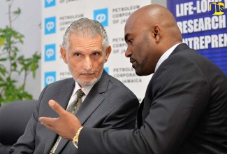 Science, Energy and Technology Minister, Dr. the Hon. Andrew Wheatley (right), in discussion with Petroleum Corporation of Jamaica (PCJ) Chairman, Russell Hadeed, at a signing ceremony for the PCJ to provide the University of Technology (UTech) with $5 million to fund a scholarship programme and research and development in renewable energy, at the PCJ in New Kingston, on March 15. 