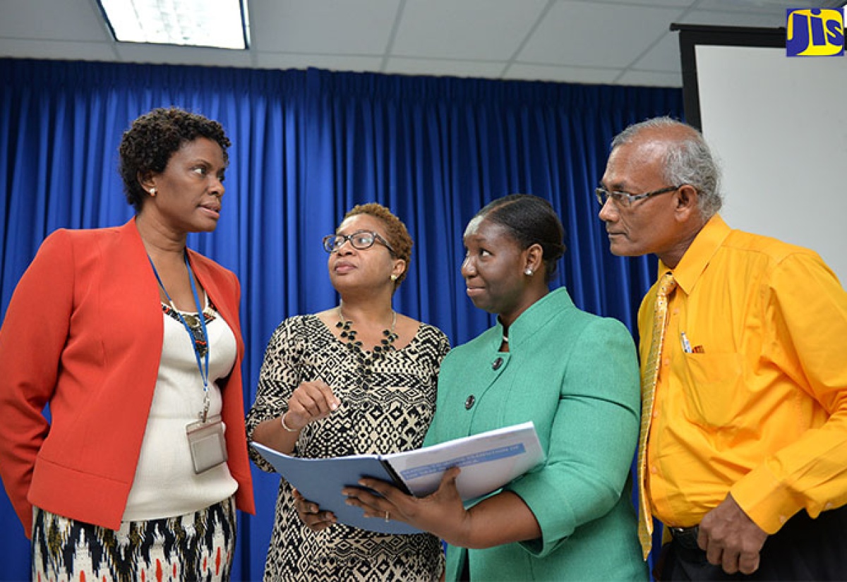 Manager of the Planning Institute of Jamaica (PIOJ) Social Protection Unit, Collette Robinson (left), converses with, from 2nd left, Social Research Consultant, Carol Watson Williams; Programme Manager for the PIOJ’s Poverty Reduction Coordinating Unit, Shelly Ann Edwards; and Director for the Institute’s Social Policy, Planning and Research Division, Easton Williams, during Thursday’s (November 3) presentation of the School-to-Work Transition of the Deaf in Jamaica Study. The presentation took place at the PIOJ’s head office in New Kingston.