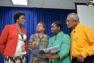 Manager of the Planning Institute of Jamaica (PIOJ) Social Protection Unit, Collette Robinson (left), converses with, from 2nd left, Social Research Consultant, Carol Watson Williams; Programme Manager for the PIOJ’s Poverty Reduction Coordinating Unit, Shelly Ann Edwards; and Director for the Institute’s Social Policy, Planning and Research Division, Easton Williams, during Thursday’s (November 3) presentation of the School-to-Work Transition of the Deaf in Jamaica Study. The presentation took place at the PIOJ’s head office in New Kingston.