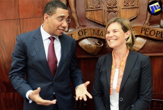 Prime Minister, the Most Hon. Andrew Holness (left), having a light exchange with World Bank Country Director, Ms. Sophie Sirtaine, ahead of a seminar at Jamaica House on July 12 with international experts and policymakers to discuss best practices and strategies for economic growth and debt management. The seminar is sponsored by the World Bank.