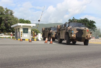 In this file photo a convoy of Bushmaster Protected Mobility Vehicles (PMVs) departs Up Park Camp.   