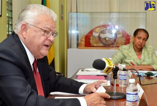 Minister of Industry, Commerce, Agriculture and Fisheries, Hon. Karl Samuda, addresses the launch of the Private Sector Organisation of Jamaica (PSOJ) updated Corporate Governance Code, during a ceremony held at the PSOJ’s Hope Road offices on December 1. Looking on is Chair of the entity’s Corporate Governance Committee, Greta Bogues.